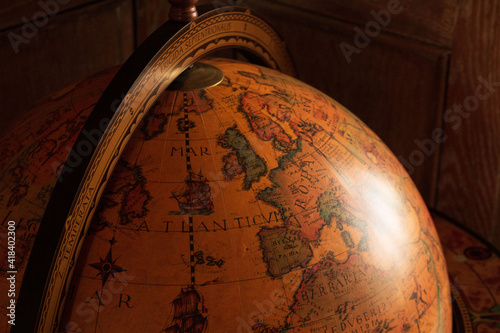 Ancient style globe before aged wooden panelling 