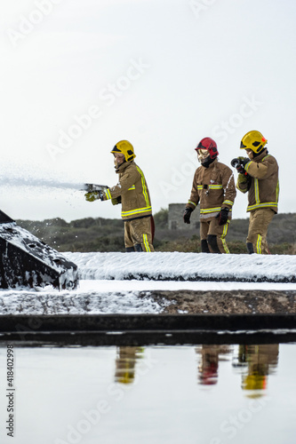 Military Airbase Fire Firefighters tackle a raging blaze on an airbase as part of military training exercises. Towering flames extinguished with the use of teamwork and specialist emergency equipment