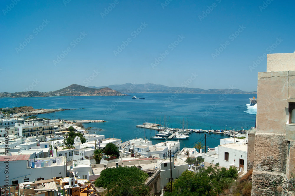 Naxos island Greece. Port view from the old town. Dramatic high angle landscape view over the beautiful harbor and bay.  Blue sky provides copy space.