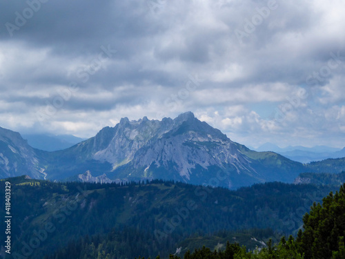 A panoramic view on the mountain chains in Hochschwab region in Austria. The slopes are steep and sharp. Endless chains of the mountains. Overcast and cloudy day.