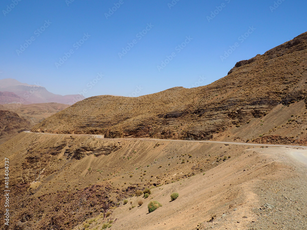 Winding route through Atlas Mountains, Morocco. Rough gravel route with amazing landscapes. Exciting virage and great viewpoint in mountainous scenery
