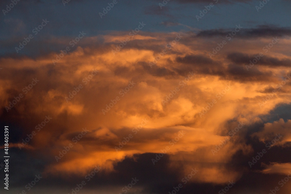 Dramatic sunset sky. Magical view of the dusk red, orange and yellow colors in the clouds and sky. 