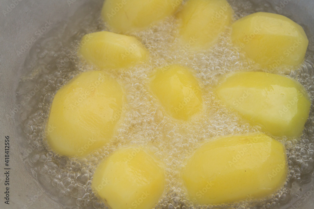 Golden potatoes are fried in boiling oil in a cauldron Golden potatoes are fried in boiling oil in a cauldron