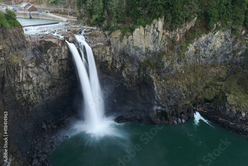 Snoqualmie Falls in Western Washington State flowing at a low level in cold weather with silky water from long exposure