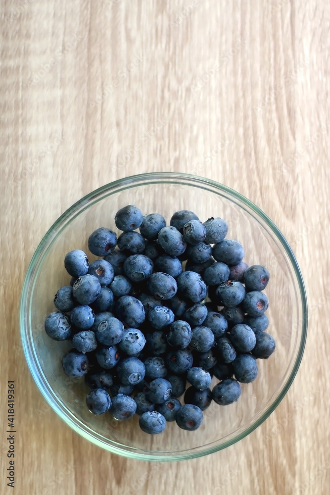 Bowl of blueberries on the table. Top view. Bowl of blueberries on the table. Top view.