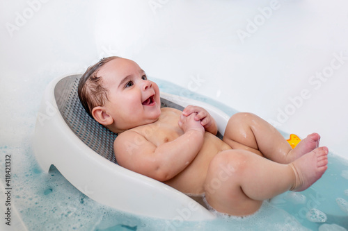 Cute, happy, chubby, naked baby in bath
