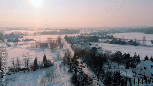Aerial view of the road through the forest covered in snow. High quality photo