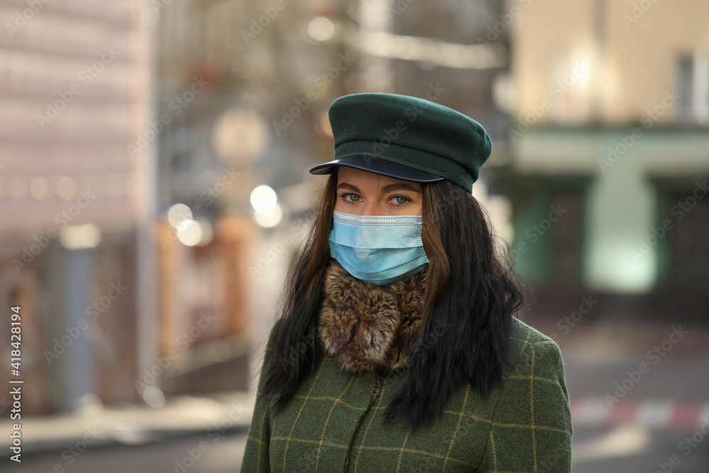 woman in a city . Girl in a mask . Coronavirus theme .