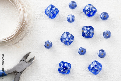 Fototapeta Naklejka Na Ścianę i Meble -  Blue Glass Beads with Wire and Wire Cutters