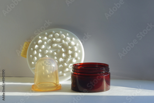 Set for anti-cellulite massage at home. Banks, massager and cream. Beauty and spa treatments.