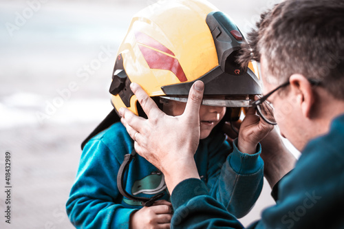Portrait of a firefighter with a boy standing