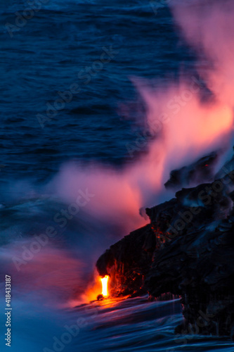 USA, Hawaii, The Big Island, Kilauea. Molten lava flowing into ocean at night.