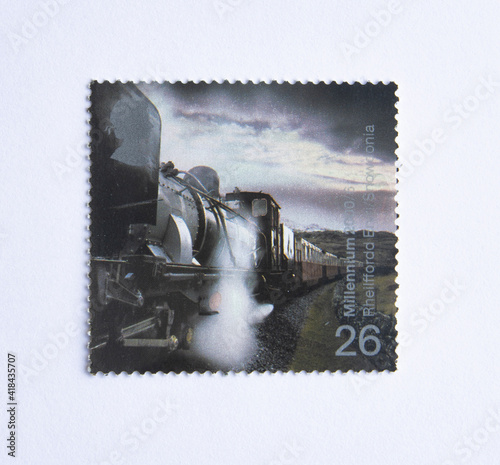 UK - CIRCA 2000: A stamp printed in UK shows image of the Garratt Steam Locomotive No. 143 pulling Train (Eheilffordd Eyri, Welsh Highland Railway), circa 2000.