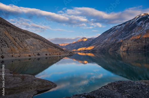 Lake Tortum , Eastern Turkey. Beautiful reflection at the surface of lake Lake Tortum at sunset. Mysterious color and atmosphere. Tortum, Erzurum, Turkey. January 2021