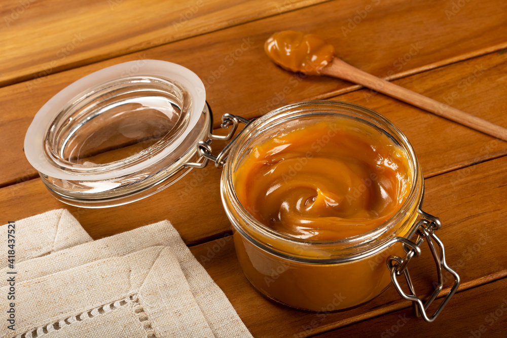 Close-up of jar full of dulce de leche. Dulce de leche, traditional sweet in Latin America. Close-up of jar full of dulce de leche. Dulce de leche, traditional sweet in Latin America.