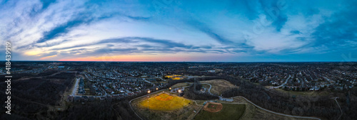 Aerial view of artificallly lit baseball field during sunset in one of the neighborhoods of Lexington  Kentucky