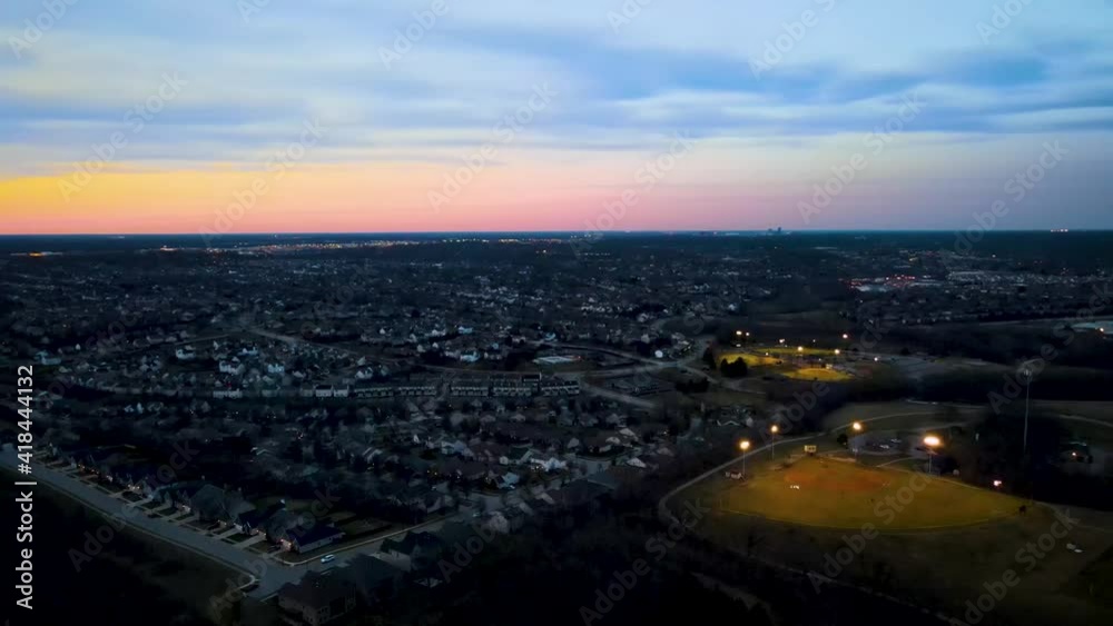 A view towards Lexington, Kentucky neighborhoods from the baseball fields of the Veterans Park during winter sunset A view towards Lexington, Kentucky neighborhoods from the baseball fields of the Veterans Park during winter sunset