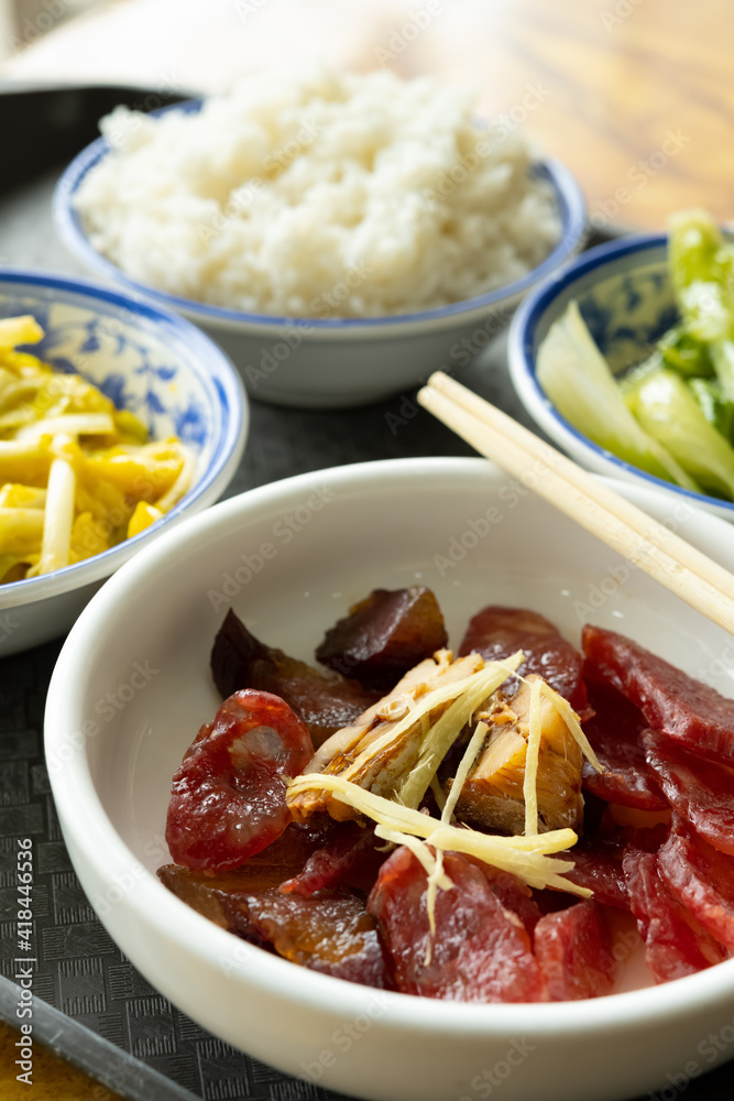 angle view fast food of Chinese style sausage and bacon and salty fish with scrambled eggs and hotbed chives and cabbage with rice vertical composition angle view fast food of Chinese style sausage and bacon and salty fish with scrambled eggs and hotbed chives and cabbage with rice vertical composition
