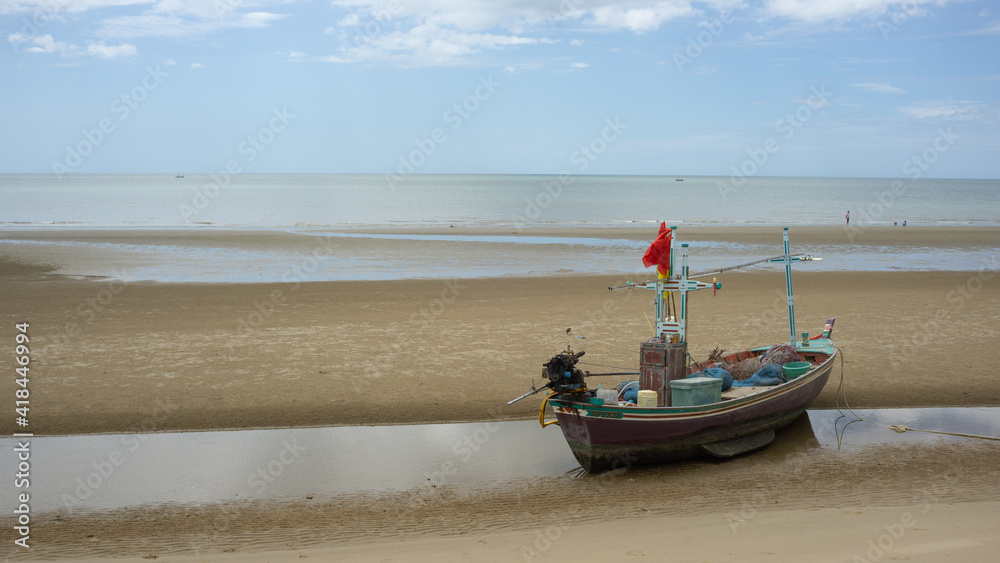 Fototapeta premium A fisherman boat was on the beach area, Hua Hin Thailand