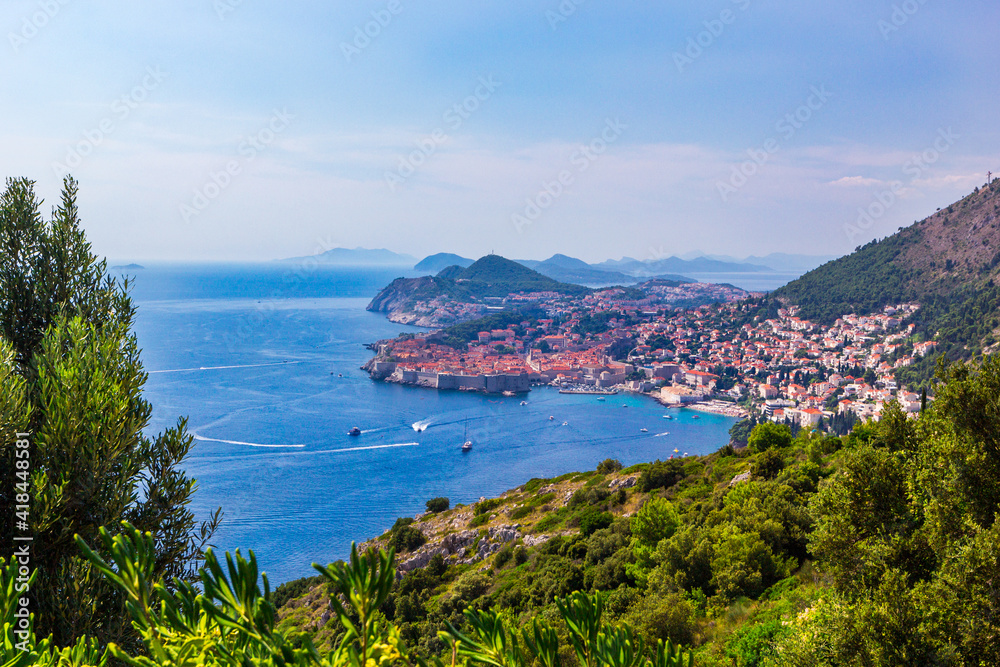 Panoramic view of Old Town medieval Ragusa and Dalmatian Coast of Adriatic Sea in Dubrovnik. Blue sea with white yachts, beautiful landscape, aerial view, Dubrovnik, Croatia