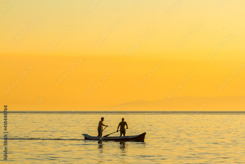silhouette of a person in a kayak