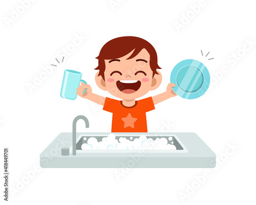 happy cute little boy washing dish in the kitchen