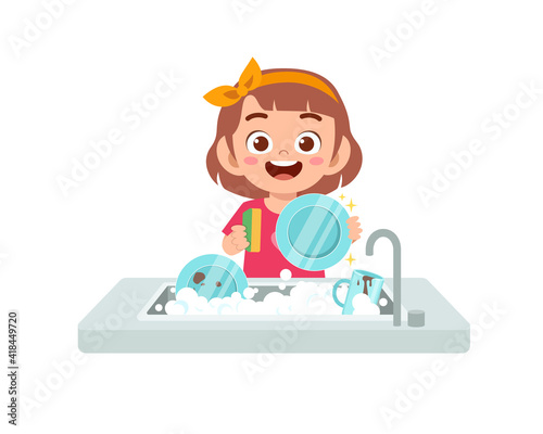 happy cute little girl washing dish in the kitchen