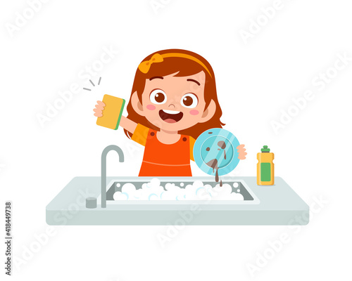 happy cute little girl washing dish in the kitchen