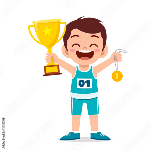 happy cute little boy holding gold medal and trophy