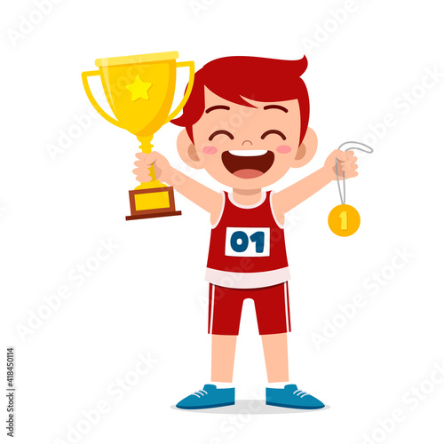 happy cute little boy holding gold medal and trophy