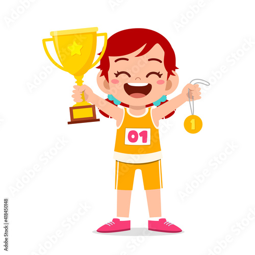 happy cute little girl holding gold medal and trophy