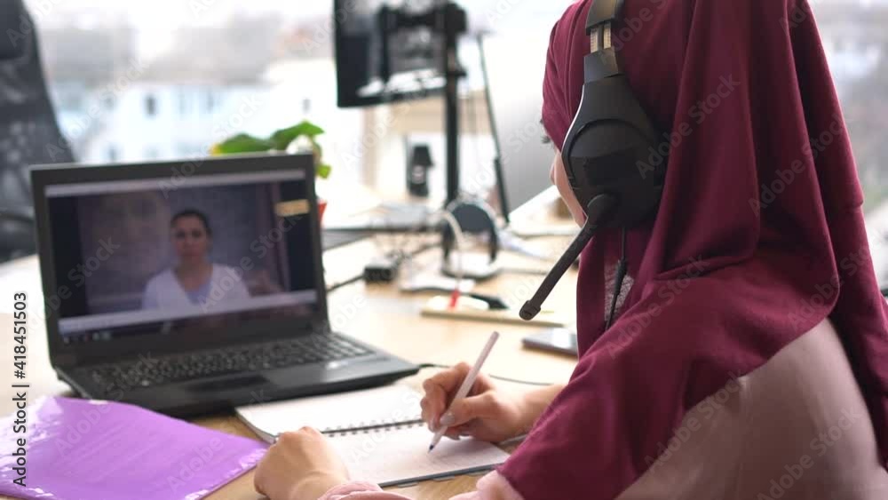 Muslim student video chats with teacher. Distance learning or Remote working during the lockdown period. Online calling meeting business education