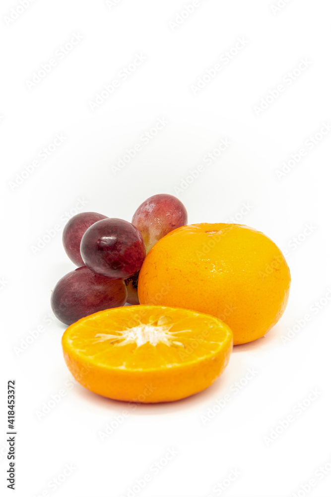 Citrus fruits and grapes on white background Citrus fruits and grapes on white background