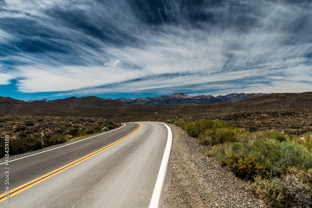 Fototapeta premium dramatic empty and lonely back road in the California desert.