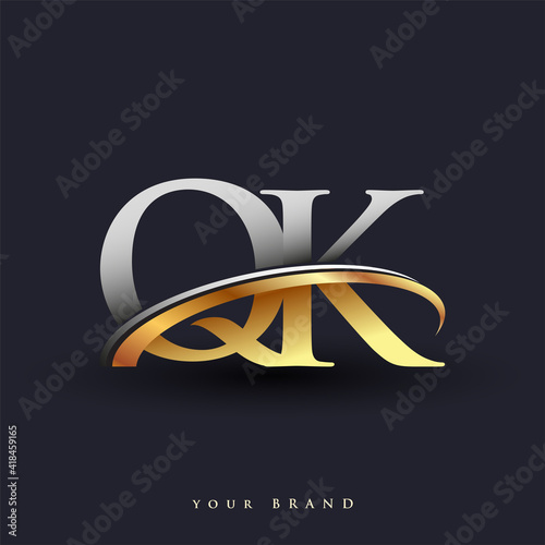 QK initial logo company name colored gold and silver swoosh design, isolated on white background. vector logo for business and company identity. photo