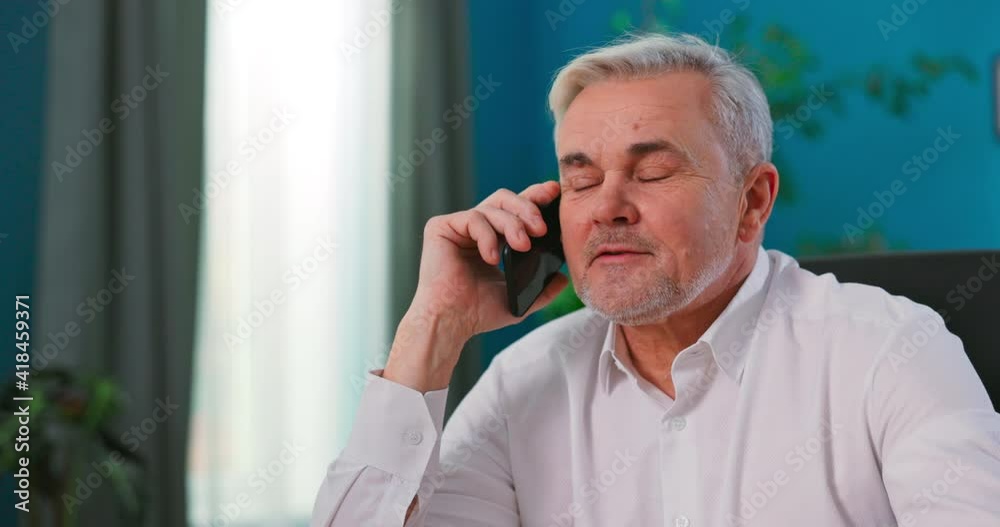 Concerned aged man hold smartphone use online consultation services talk to clinic or bank assistant get information remotely express complaints. Serious old male solve problem distantly by phone call Concerned aged man hold smartphone use online consultation services talk to clinic or bank assistant get information remotely express complaints. Serious old male solve problem distantly by phone call