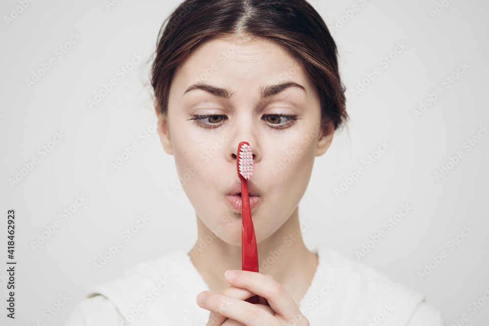 cheap woman in white robe toothbrush hygiene in the morning close-up cheap woman in white robe toothbrush hygiene in the morning close-up