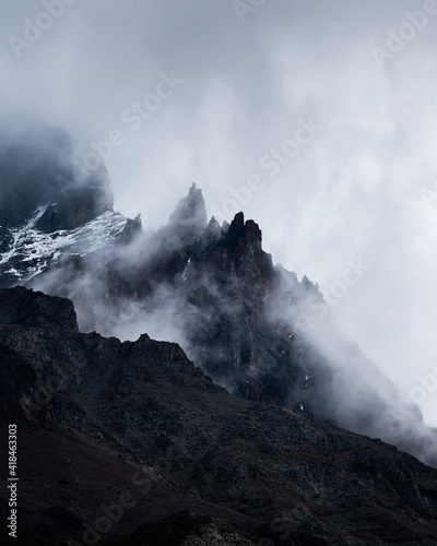 A peak of a black mountain in a cloudy day in Torres del Paine National Park