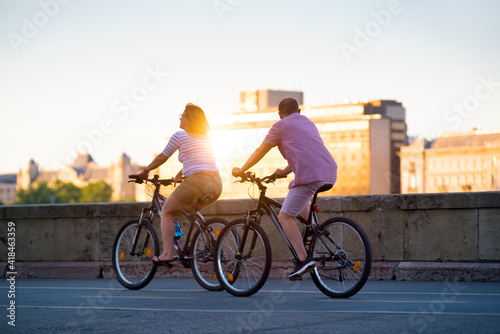 Mature couple riding bikes in the city