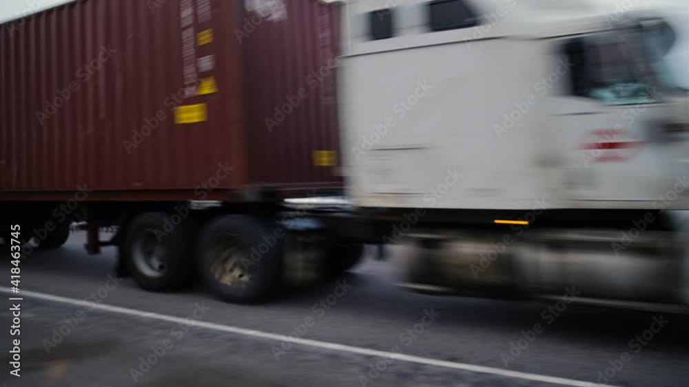 A truck is speeding along the Autobahn at great speed. A trucker is driving along the high-speed road. A large truck with a burgundy body is driving along the Autobahn at high speed. A truck is speeding along the Autobahn at great speed. A trucker is driving along the high-speed road. A large truck with a burgundy body is driving along the Autobahn at high speed.