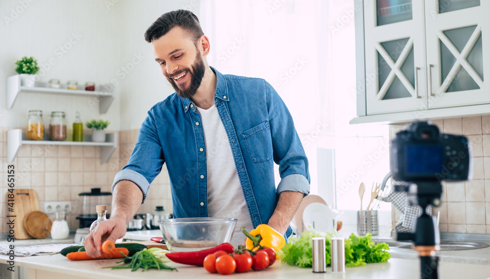 Real man kitchen blog at home while guy cooks fresh healthy vegan salad on the camera Real man kitchen blog at home while guy cooks fresh healthy vegan salad on the camera