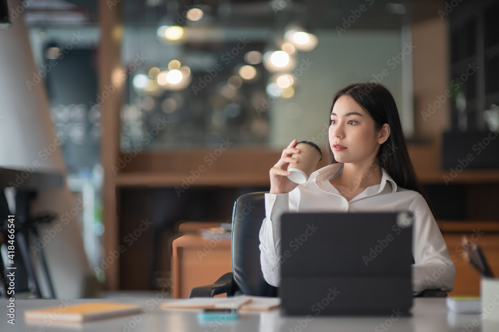 Businesswoman having tea or coffee in home office. Businesswoman having tea or coffee in home office.