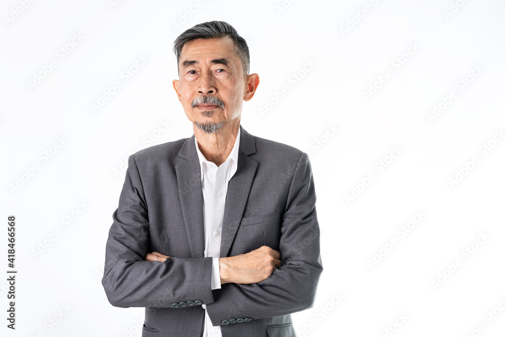 A senior Asian businessman in a classic gray suit shirt is happy, smiles, and proud. He has Crossed his arms with two hands. Studio shot over white background. Elderly, Positive and vision Concept A senior Asian businessman in a classic gray suit shirt is happy, smiles, and proud. He has Crossed his arms with two hands. Studio shot over white background. Elderly, Positive and vision Concept
