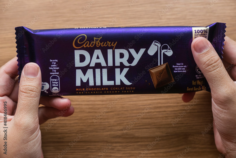 KEDAH,MALAYSIA MARCH 6TH,2021 A hand holding Cadbury Dairy Milk