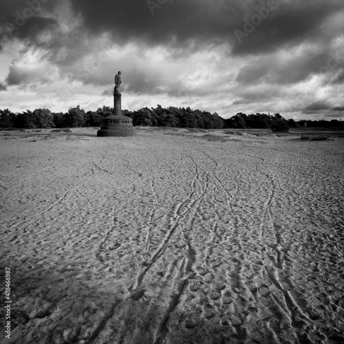 Ede Netherlands - 25 December 2020 - Dark skies over monument General de Wet in National Park Hoge Veluwe in Netherlands photo