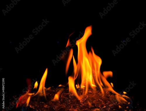 Big orange flame of outdoor fire pit close up and isolated  