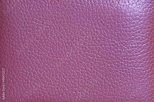 Texture of magenta colored cow leather surface for abstract background