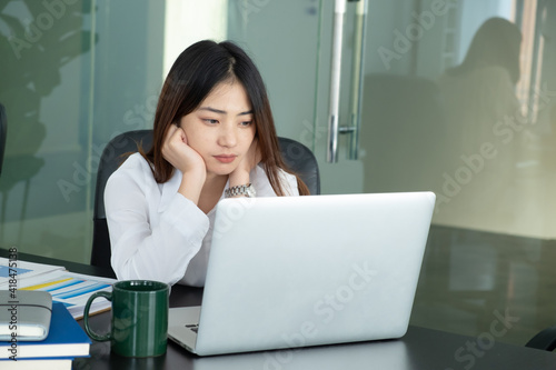 Cropped shot of businesswoman headache while working with laptop in the office. photo