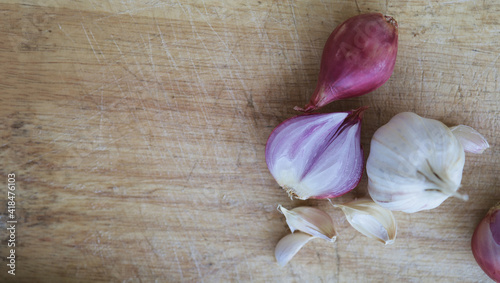 Onion and garlic for cooking on old wooden background