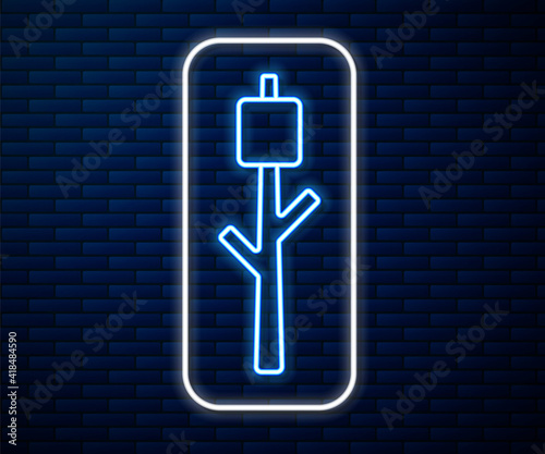Glowing neon line Marshmallow on stick icon isolated on brick wall background. Vector.
